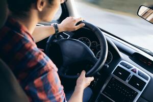 A man driving a car | Best chiropractor Ann Arbor 