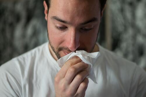 A man using a tissue | Chiropractors near me