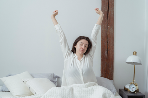 A woman stretching after waking up | Chiropractor Ann Arbor