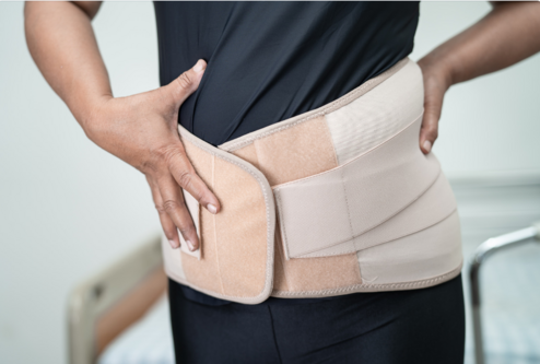 A woman wearing a back brace | Best chiropractor Ann Arbor