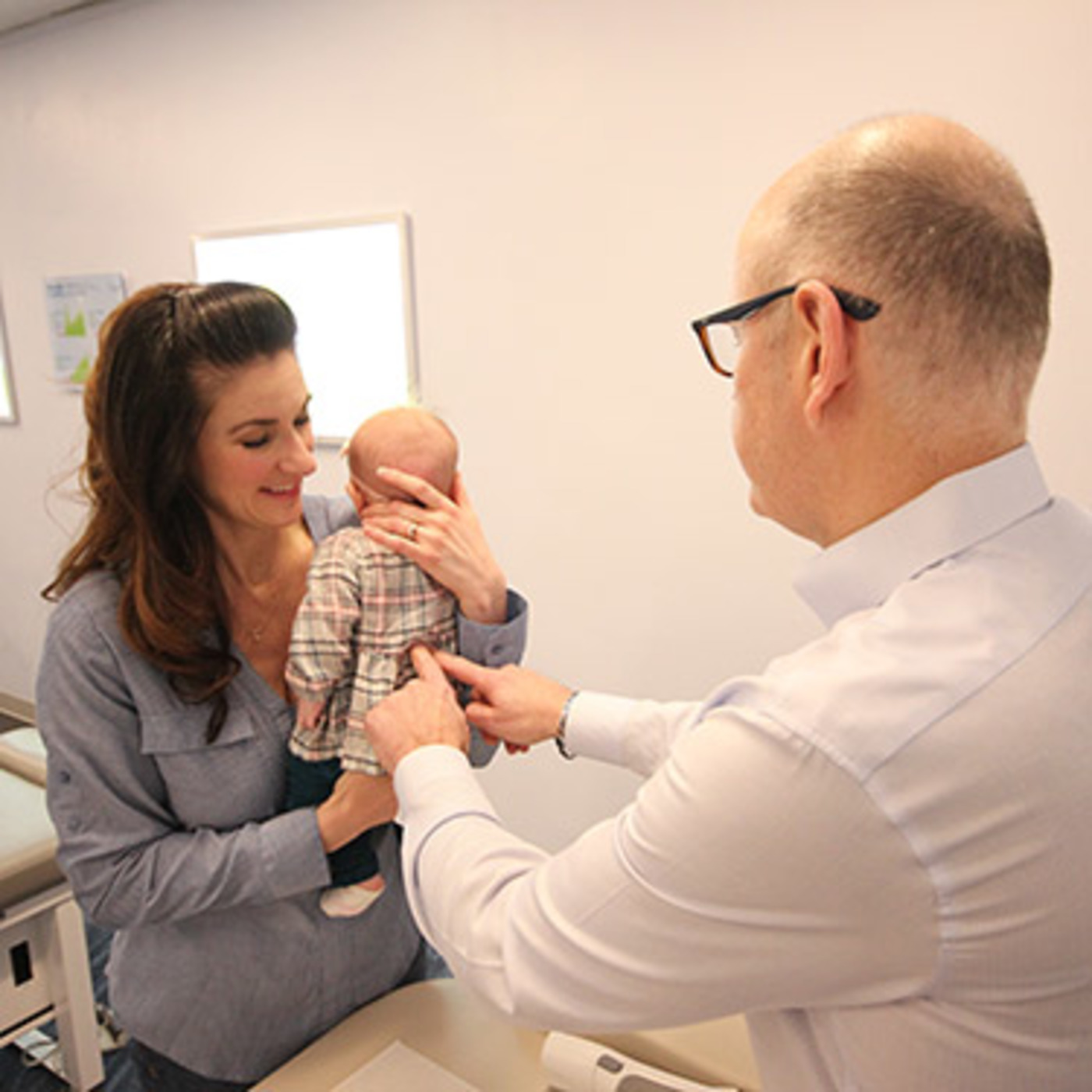Dr. Bill chiropractor Ann Arbor adjusting baby.